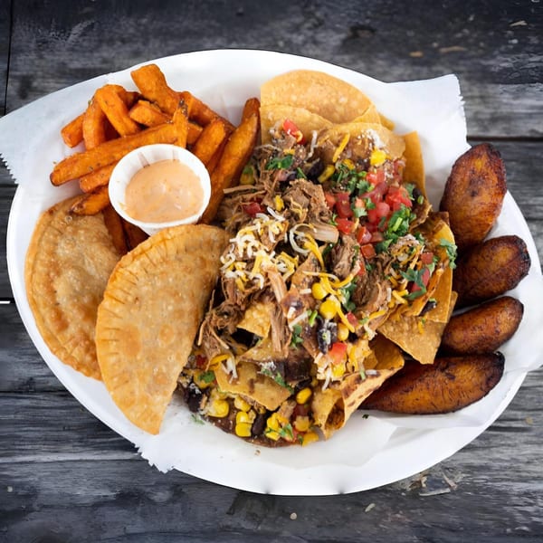 A Latin Chicks platter with nachos, empanadas, sweet potato fries, and fried plantains.